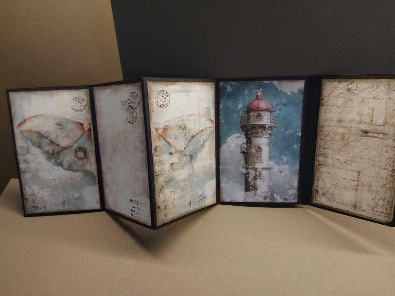 Foldable map or book with lighthouse illustration on a beige surface