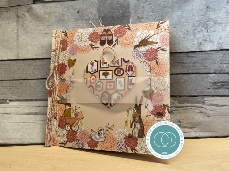Decorative notebook with floral and animal pattern on a wooden surface