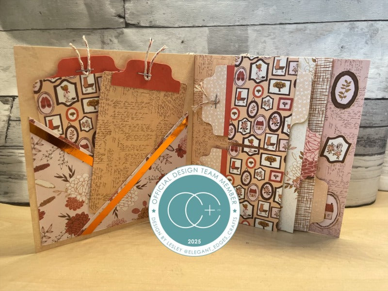 Decorative notebook with patterned pages and a pencil on a wooden surface, featuring a Cricut Design Team Member badge.