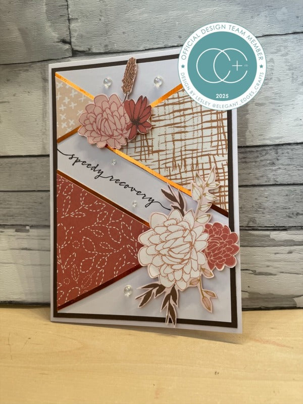 Greeting card with floral design and 'speedy recovery' text on a wooden surface