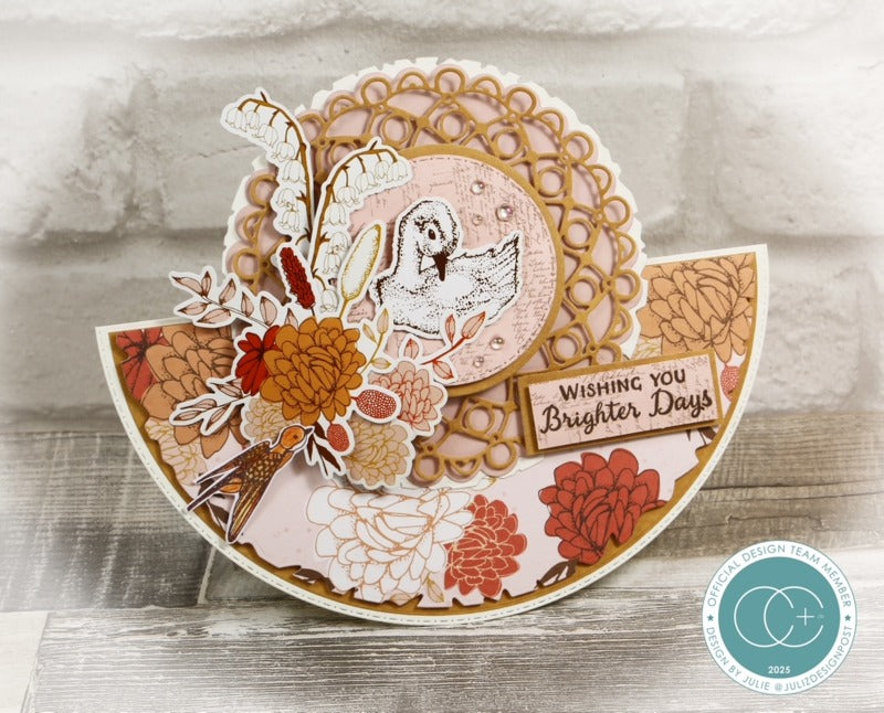 Decorative card with floral design and text 'Wishing you Brighter Days' on a wooden surface.