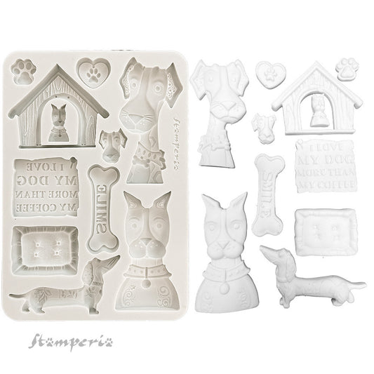 Set of white silicone mold shapes with dog-themed designs on a white background