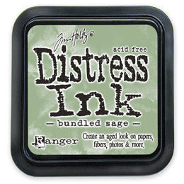 A Distress Ink Pad by Ranger in a Bundled Sage color, which is a greenish gray, used for creating aged vintage effects on paper.