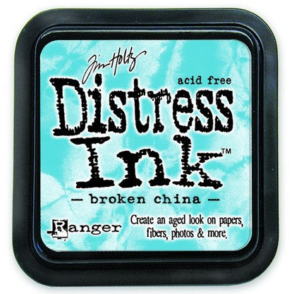 A Distress Ink Pad in a Broken China color by Tim Holtz, used for creating aged vintage effects on paper, fibers, photos, and more.